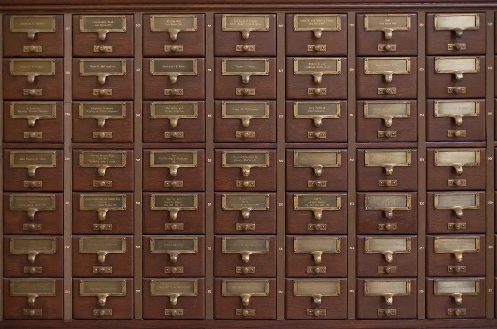 Rows of wooden card-catalog drawers with brass label holders